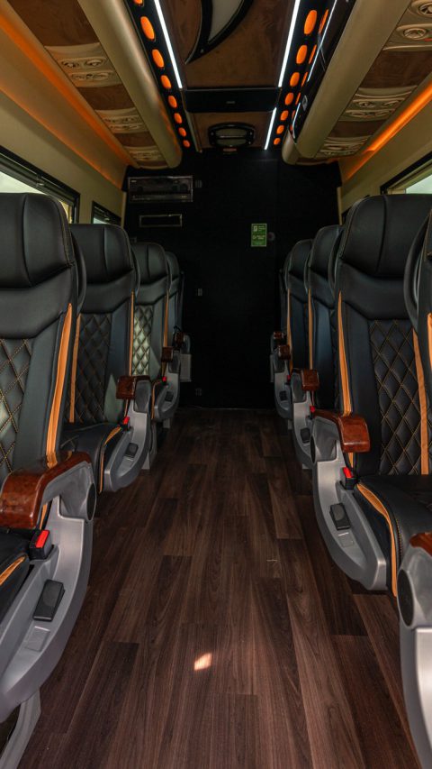 VIP Buses Mercedes Sprinter 9 Seater Minibus aisle to the rear door under orange lighting