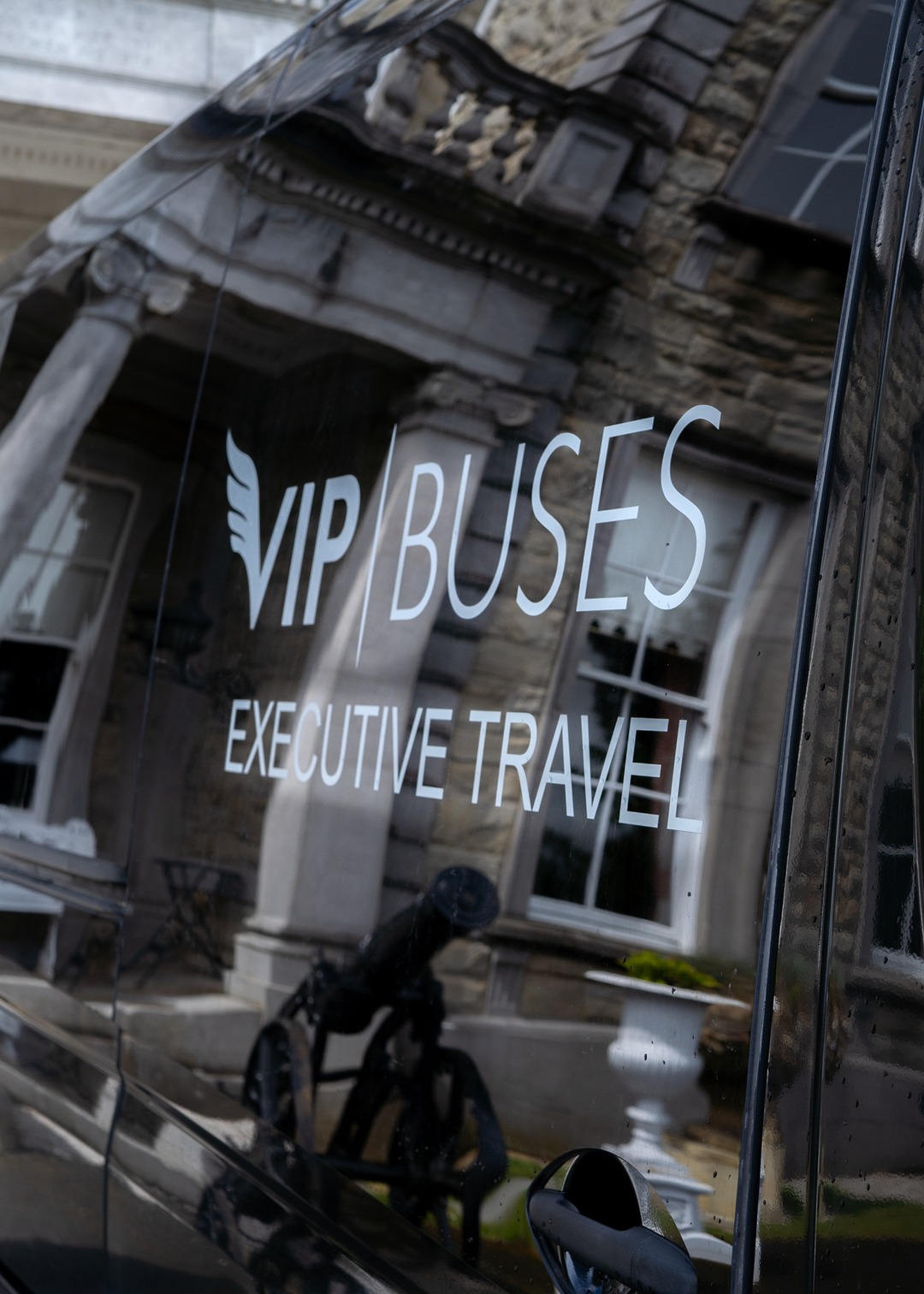 VIP Buses Mercedes Sprinter 9 Seater Minibus close up of the livery with the house reflected