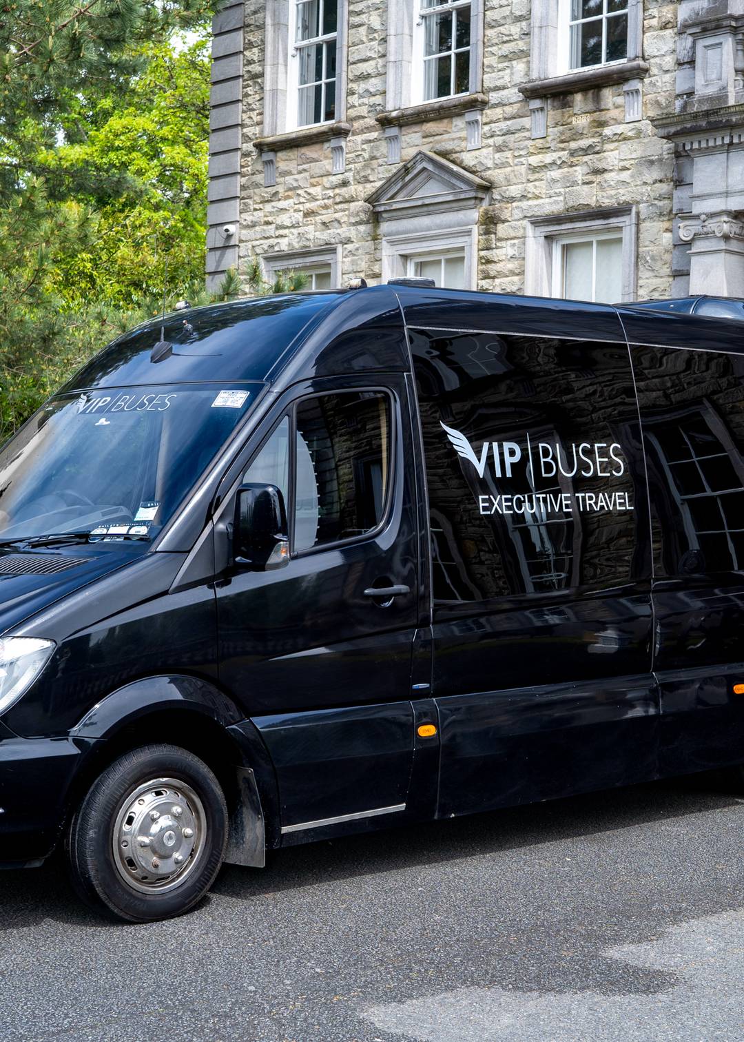 VIP Buses Mercedes Sprinter 9 Seater Minibus front three quarter outside the portico