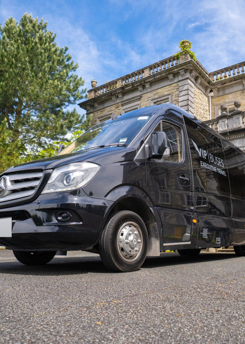 VIP Buses Mercedes Sprinter 9 Seater Minibus low angle on the drive with a cannon behind
