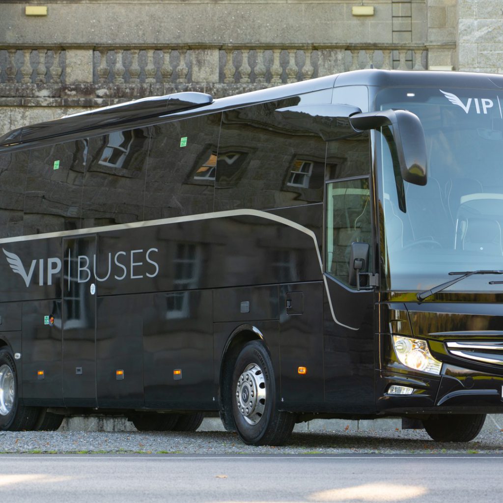 VIP Buses Mercedes Turismo 41 Seater Coach front three quarter beside a granite country house