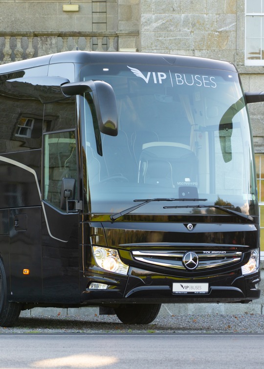 VIP Buses Mercedes Turismo 41 Seater Coach front three quarter beside a granite country house